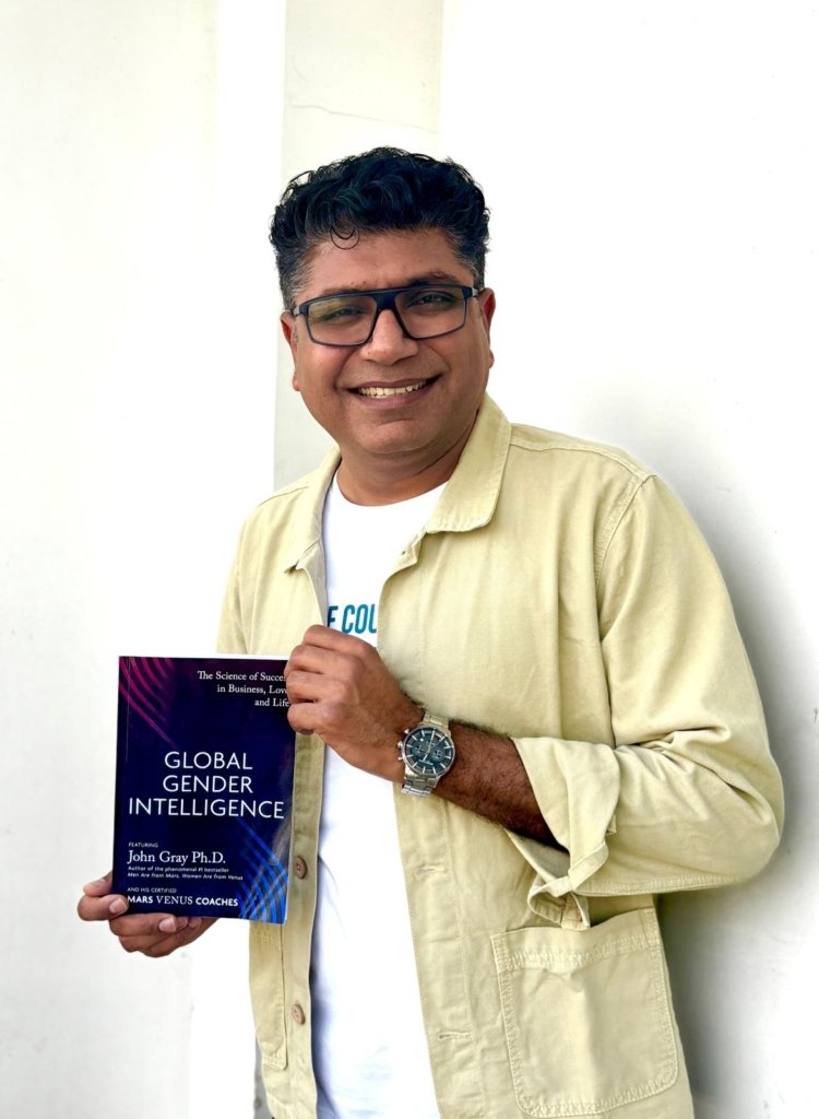 Kawal Arora holding a copy of Global Gender Intelligence