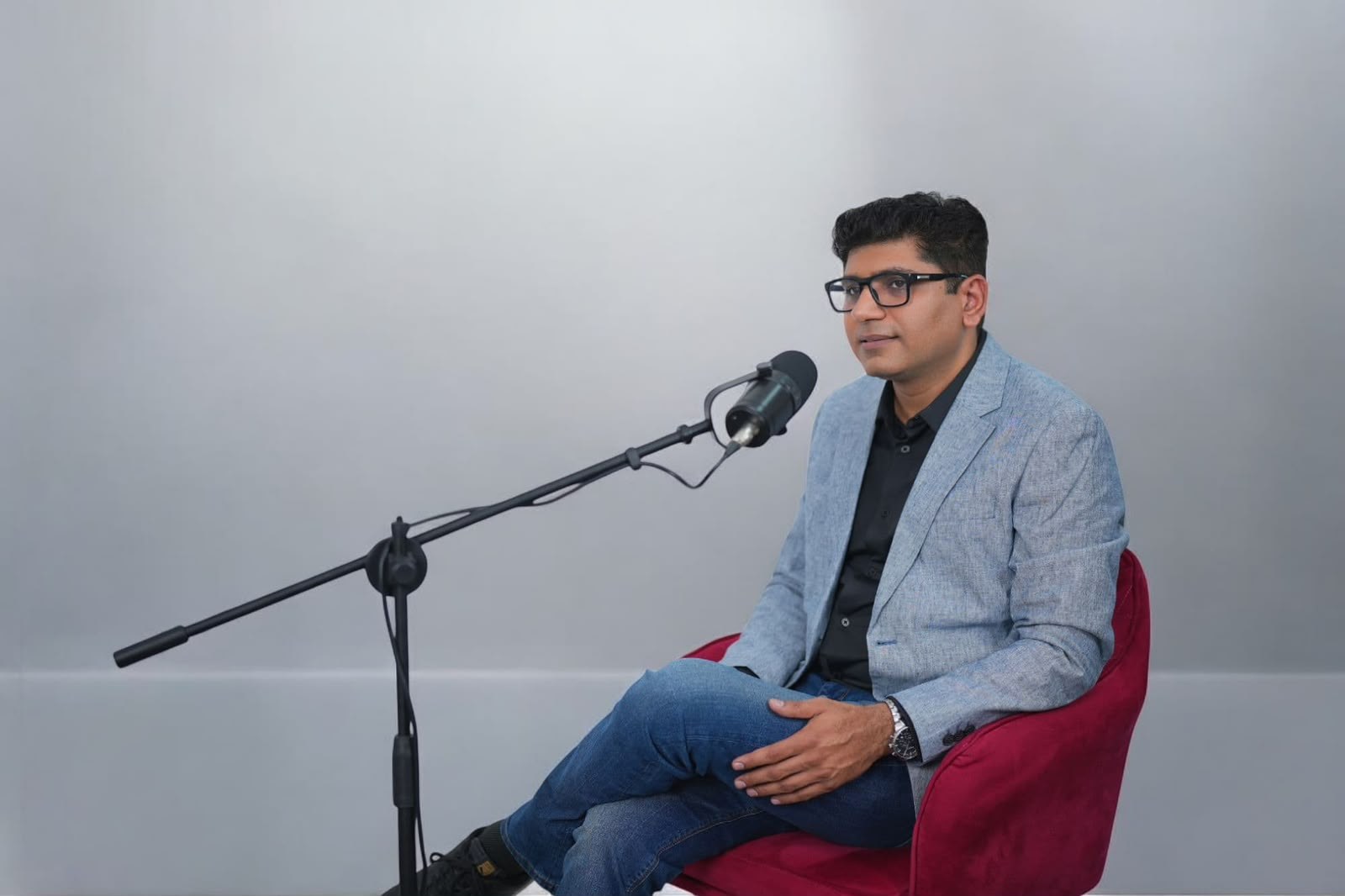 Kawal Arora seated with a microphone during a leadership coaching conversation