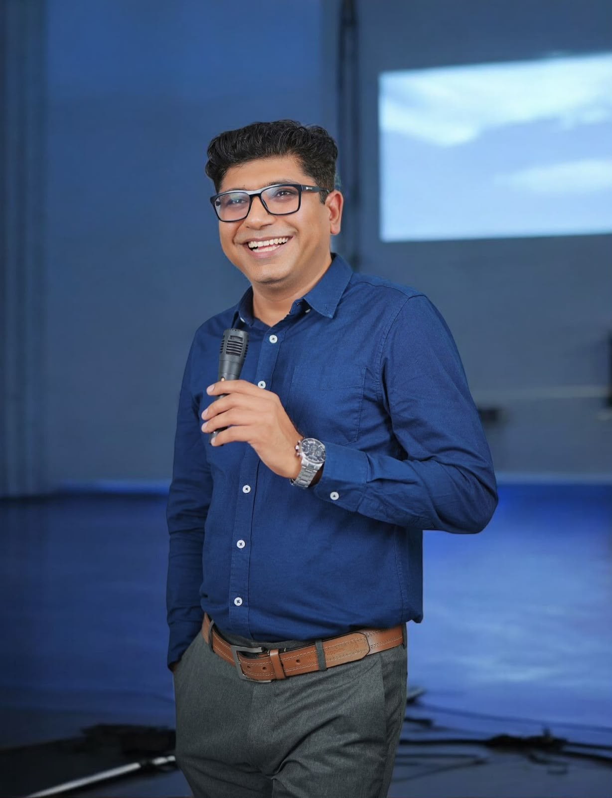 Kawal Arora speaking on stage at a leadership keynote